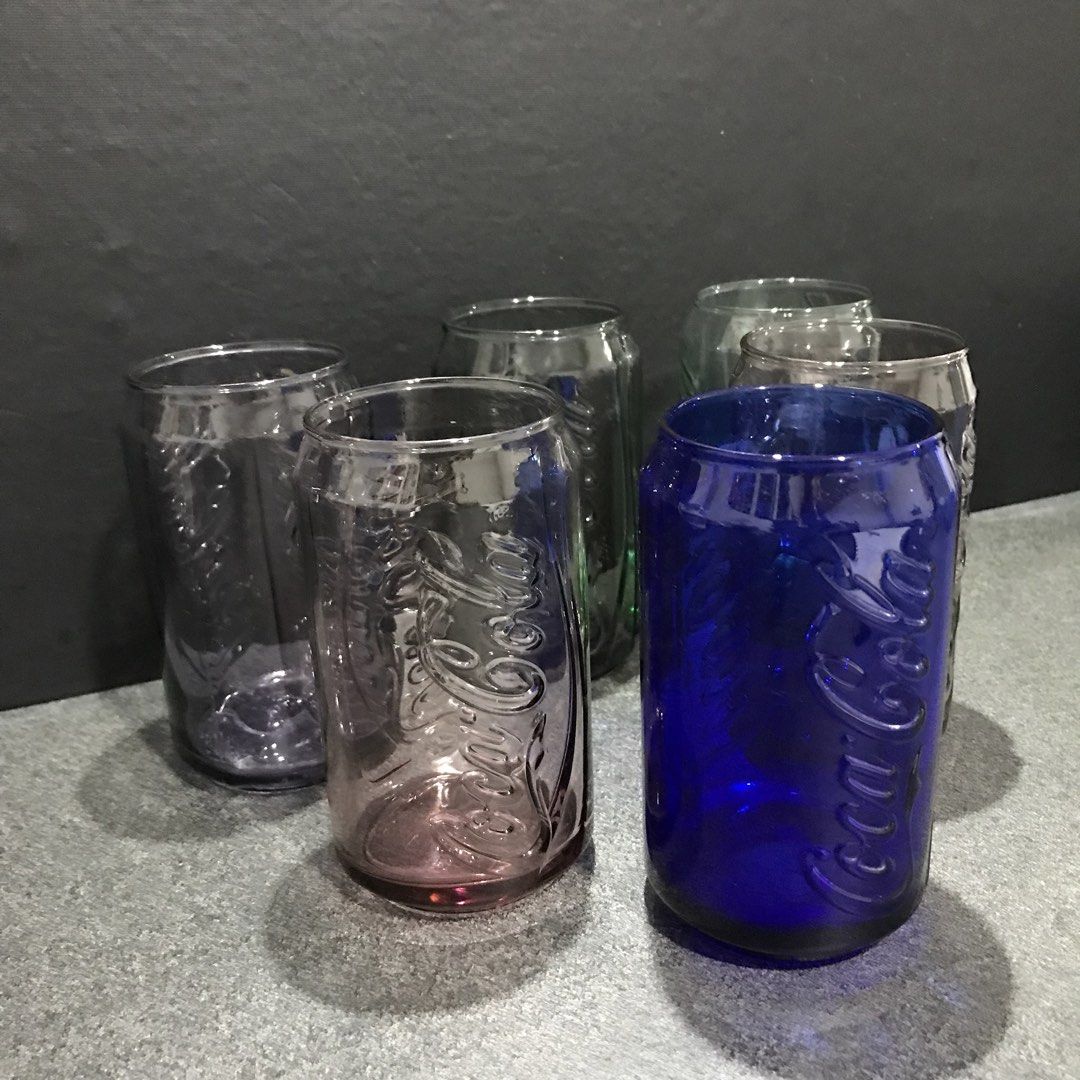 Coca-Cola Can Shaped Glasses Set (Category: Vintage Collectibles) located in Baao. Submitted by all.things.japan (Listing ID 1463583971, Image 2). Description: - Set of 6 Coca-Cola glasses - Unique design shaped like classic soda cans - Includes: 1 blue, 2 pinkish-purple, 1 green, 2 clear glasses - Ideal for collectors or everyday use - Adds a fun and unique touch to your drinkware.