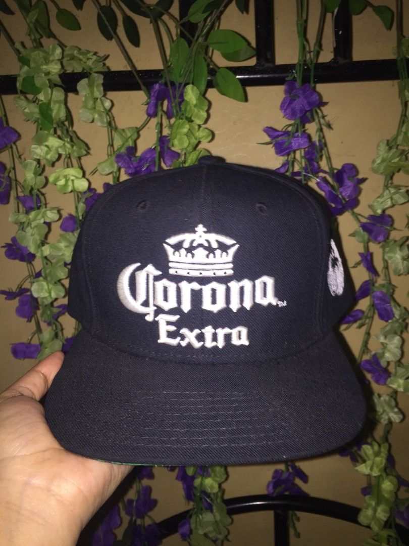 Corona Extra Snapback Cap Find Your Beach (Category: Caps & Hats) located in Manila. Submitted by mr_kim01 (Listing ID 1463610273, Image 1). Description: - Black Corona Extra snapback hat - Features iconic Corona logo on the front - 'Find your beach.' embroidered on the back - Green underside of the brim - One size fits most - Ideal for casual outings or a day at the beach.