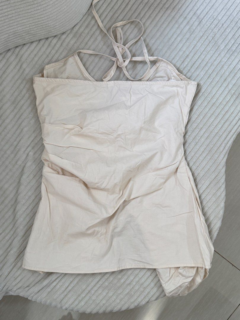 Cream Halter Neck Rushed Front Draped Top (Category: Sleeveless) located in Dasmarinas. Submitted by ella.i2 (Listing ID 1463635625, Image 3). Description: - Used once - Cream halter neck top - Unique rushed front and draped detailing - Ties at the back of the neck - Lightweight fabric - Versatile: great for dressing up or down - Note: Small mark on fabric, shown in the last photo 📍Dasma.
