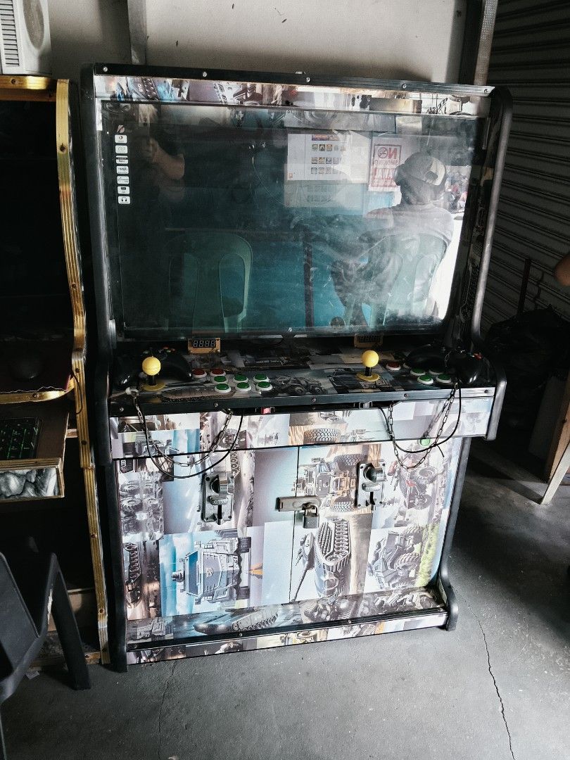 Custom Arcade Machine with Multiple Games (Category: Nintendo) located in Manila. Submitted by juan.hundred04 (Listing ID 1463646836, Image 1). Description: - Full-size arcade machine - Large screen for immersive gameplay - Dual joysticks with multiple buttons - Futuristic, mechanical themed graphics - Includes an Xbox controller for versatile gaming - Ideal for retro gaming enthusiasts - Ready for pickup.