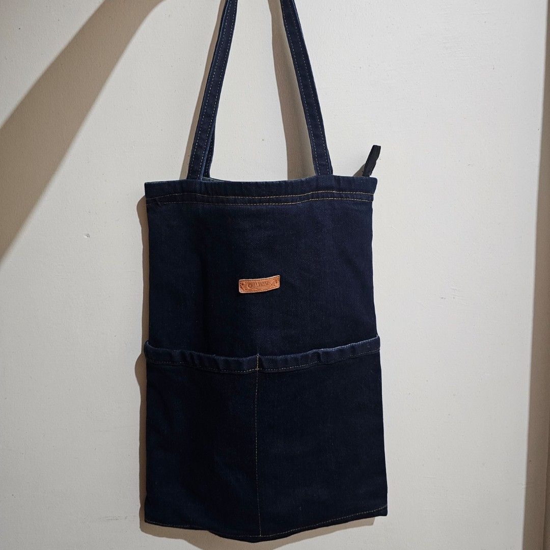 Denim Tote Bag (Category: Tote Bags) located in Baguio. Submitted by riesbydia (Listing ID 1463589974, Image 1). Description: - Dark wash denim tote bag - 2 front and inside pockets - with Zipper - can fit 16 inches, long folders, etc..