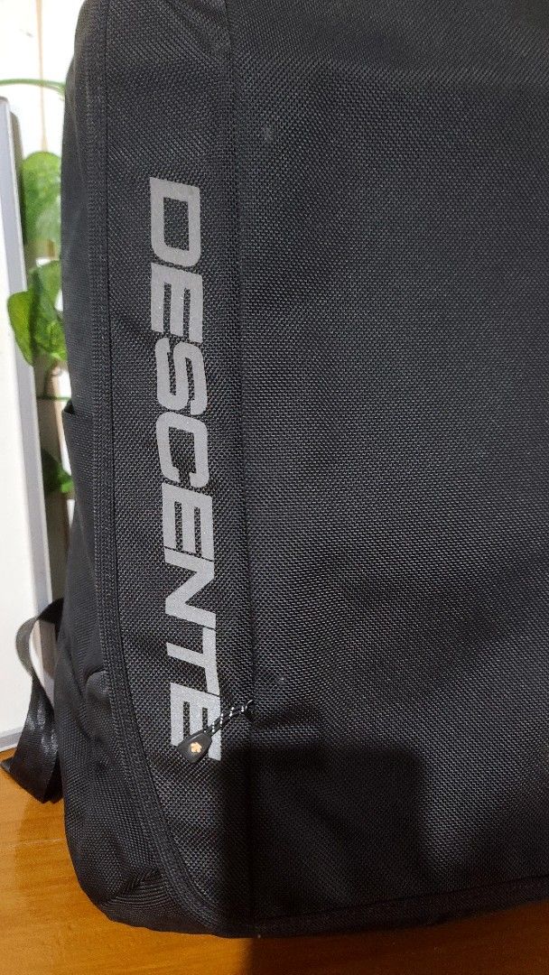 Descente Backpack 19 x 13 inch (Category: Backpacks) located in Baguio. Submitted by phoeberose33384 (Listing ID 1463739813, Image 2). Description: - Black Descente backpack - Dimensions: 19 x 13 inches - Features iconic Descente logo and arrow symbol - Multiple straps and zippers for organization - Padded shoulder straps for comfort - Ideal for everyday use or travel.