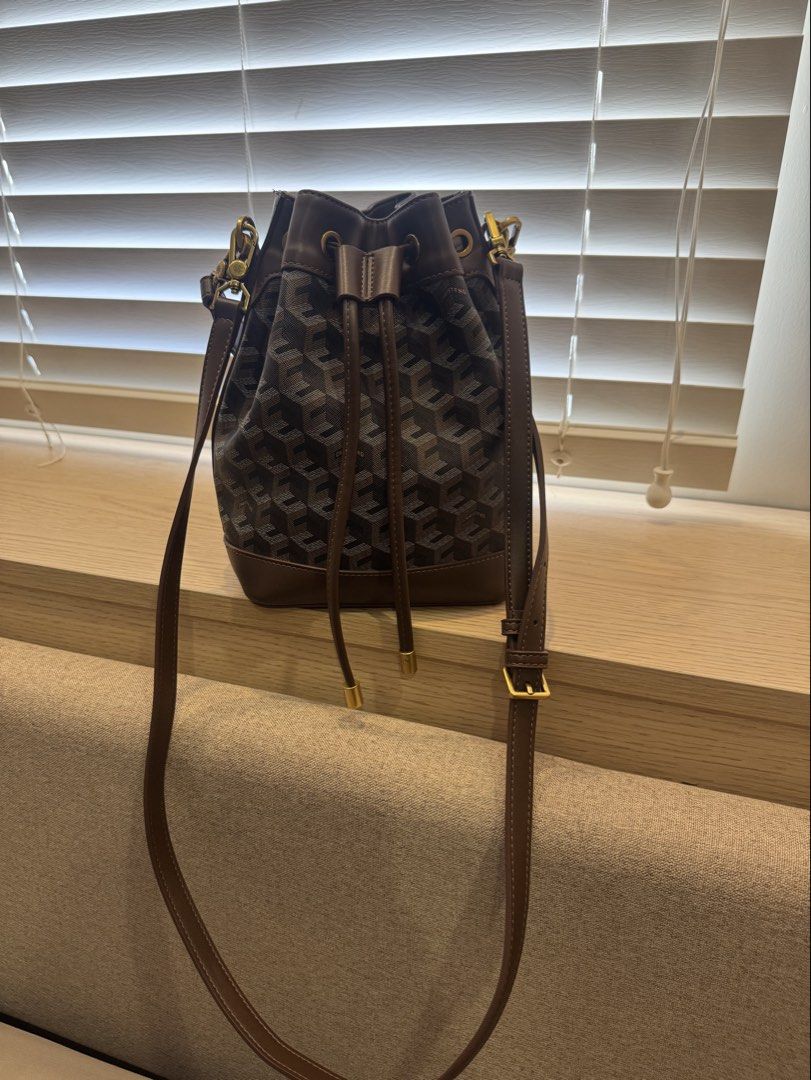 Designer Monogram Bucket Bag with Leather Trim (Category: Cross-body Bags) located in San Fernando. Submitted by jelajoybasco (Listing ID 1463613991, Image 1). Description: - Classic bucket bag design - Features a repeating monogram pattern - Luxurious leather trim and drawstrings - Elegant gold-tone hardware - Adjustable shoulder strap for comfort - Ideal for everyday use.