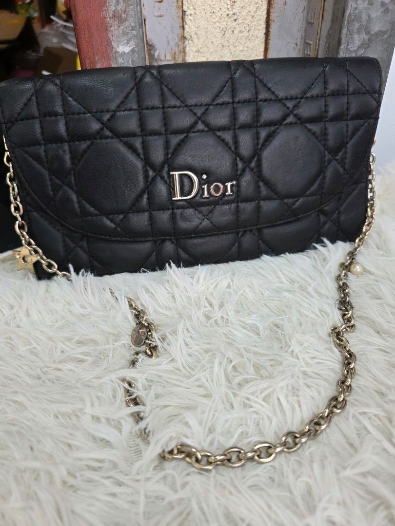 Dior Black Quilted Leather Wallet on Chain (Category: Luxury Bags & Wallets) located in Lemery. Submitted by venus23 (Listing ID 1463739892, Image 1). Description: - Black Dior Wallet on Chain - Quilted Leather with Silver Hardware - Elegant Pearl Detail on Strap - Interior: Card Slots and Zip Pocket - Signs of wear on leather and hardware, adding character - Still a stylish and functional accessory.