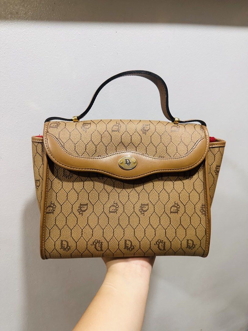 DIOR Top handle bag (Category: Purses & Pouches) located in Batangas. Submitted by stopandshopforluxury (Listing ID 1463736629, Image 1). Description: Guaranteed Original 💯 Flaw inside as seen on the photo. Free organizer can send more photos upon request. What you see is what you get. Shipping via Lalamove, J&T, and LBC Disclaimer: This is a preloved bag. Actual condition is shown in photos. Expect normal signs of wear. Colors may slightly vary
