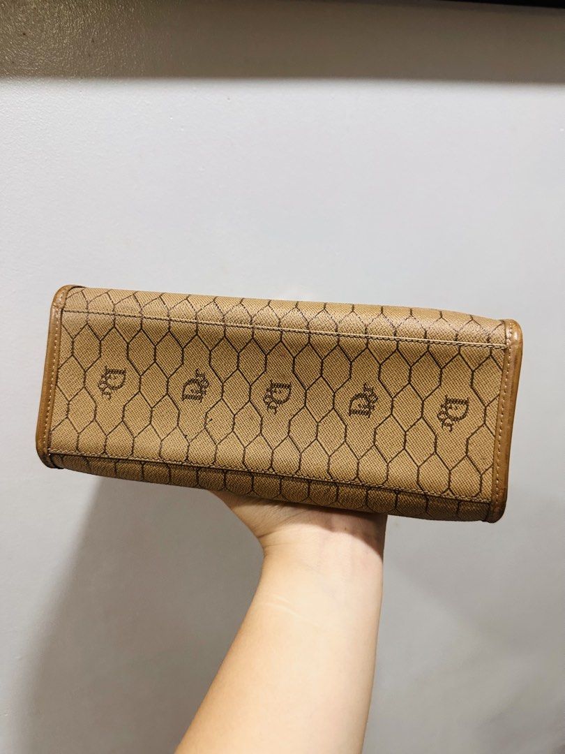 DIOR Top handle bag (Category: Purses & Pouches) located in Batangas. Submitted by stopandshopforluxury (Listing ID 1463736629, Image 2). Description: Guaranteed Original 💯 Flaw inside as seen on the photo. Free organizer can send more photos upon request. What you see is what you get. Shipping via Lalamove, J&T, and LBC Disclaimer: This is a preloved bag. Actual condition is shown in photos. Expect normal signs of wear. Colors may slightly vary