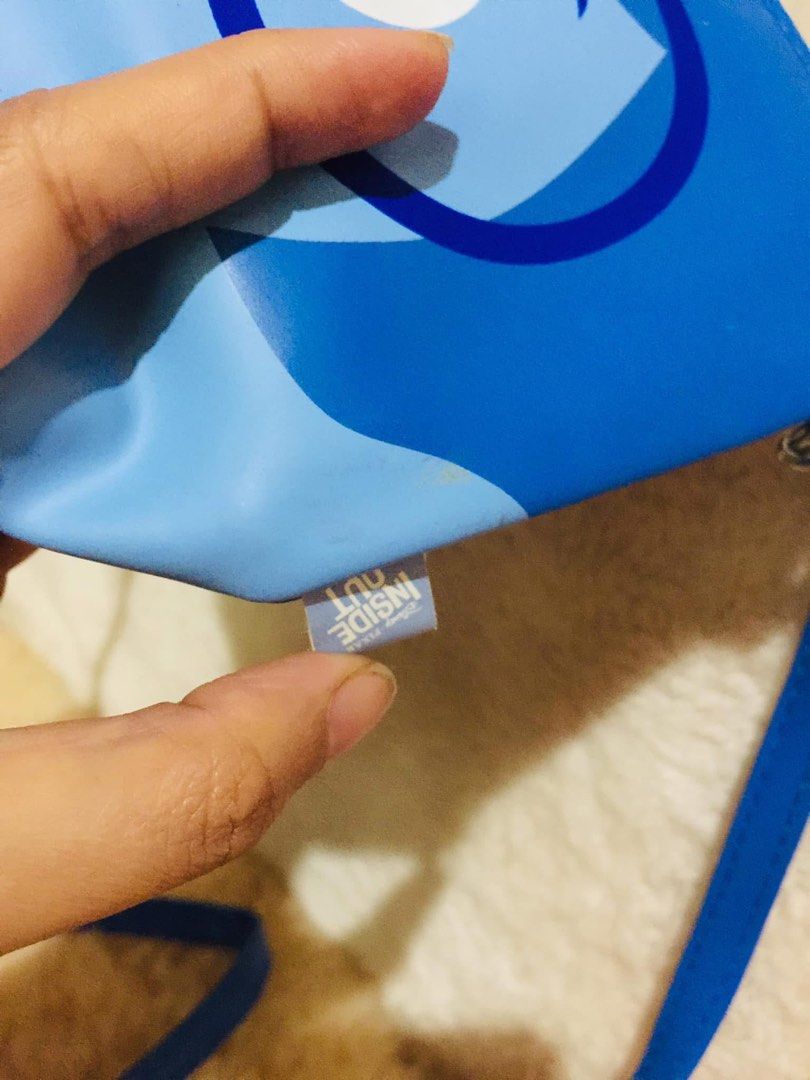 Disney Pixar Inside Out Sadness Blue Pouch Bag (Category: Purses & Pouches) located in Baguio. Submitted by izza_thrifty (Listing ID 1463664845, Image 3). Description: - Adorable blue pouch featuring Sadness from Disney's Inside Out. - Secure zipper closure to keep your items safe. - Comes with a convenient detachable strap. - Features a clear plastic interior, perfect for organizing small essentials. - Size is comparable to a smartphone, making 