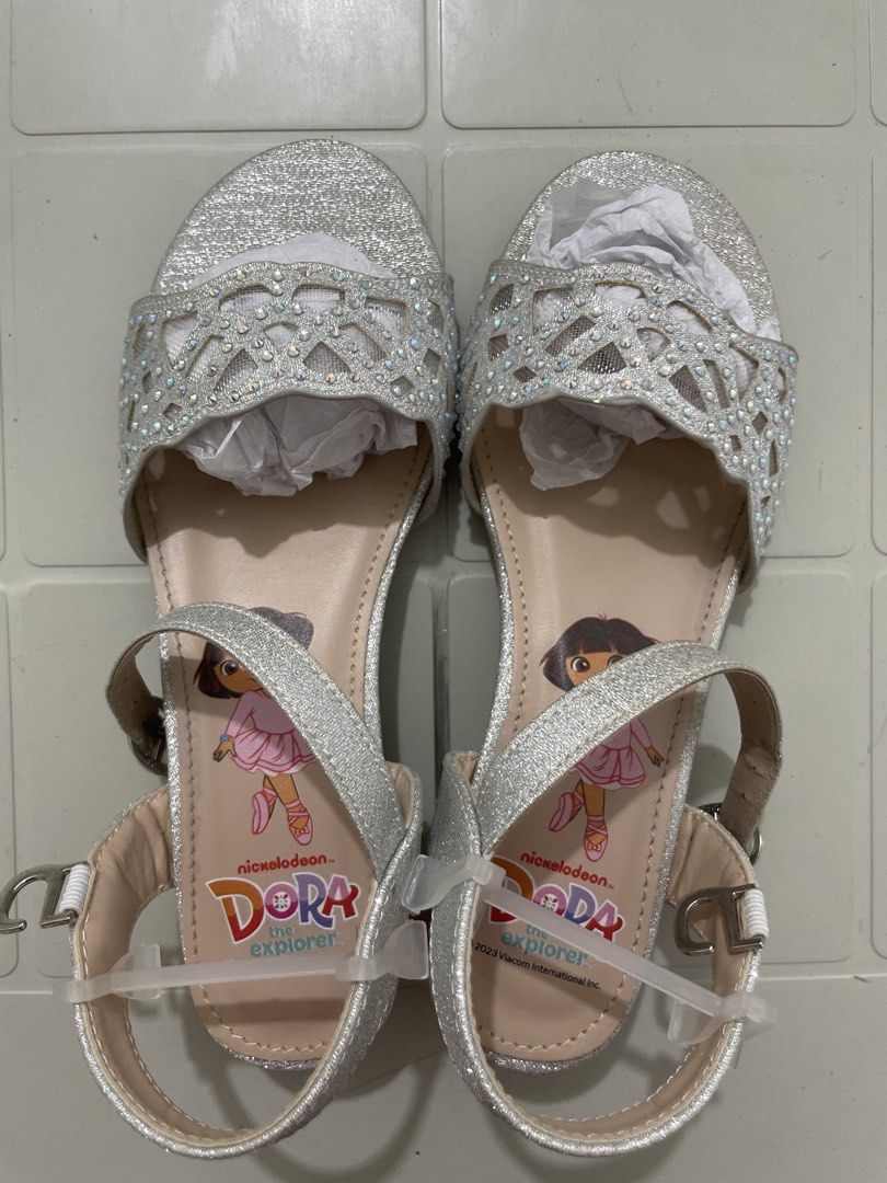 Dora the Explorer Silver Glitter Sparkle Sandals (Category: Babies & Kids Fashion) located in Quezon City. Submitted by sanri23 (Listing ID 1463611123, Image 1). Description: - Sparkly silver sandals featuring Dora the Explorer - Glittery finish with cute cut-out details - Rhinestones on the front strap - Adjustable ankle strap for a secure fit - Chunky block heel design - Perfect for little Dora fans! - Used once only. .