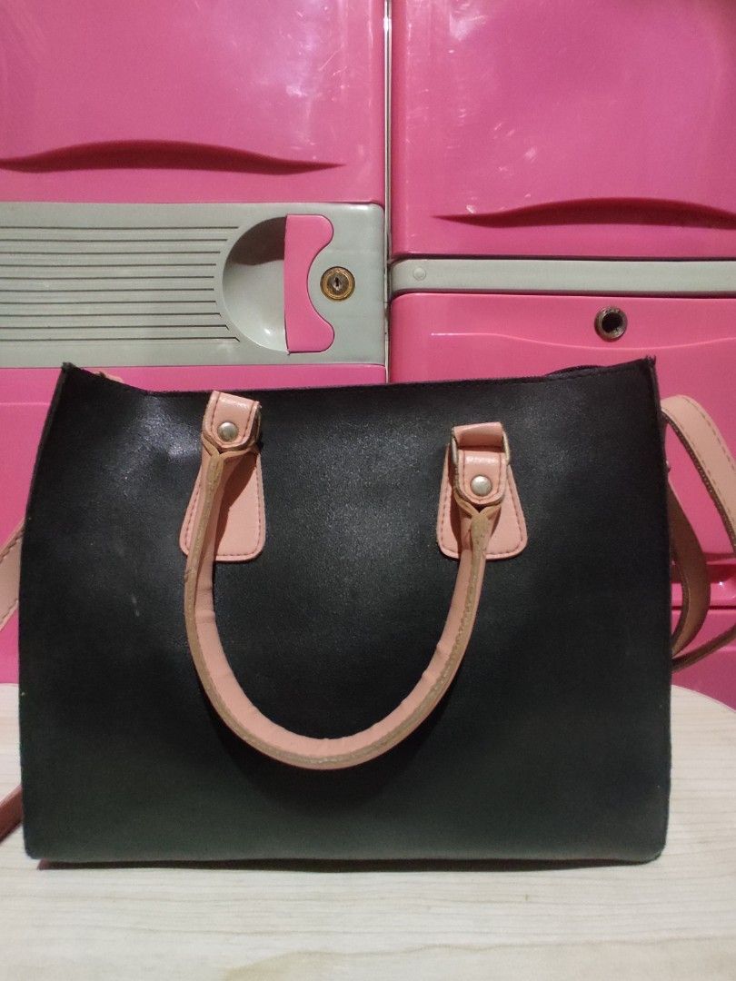 EGG Handcrafted Philippines Black & Pink Tote Bag (Category: Tote Bags) located in Manila. Submitted by xiaochao.16 (Listing ID 1463738999, Image 2). Description: - Stylish black tote bag - Contrasting light pink handles and strap - Interior includes a zippered pocket and main compartment - Proudly made in the Philippines - Minor signs of wear on interior lining - Ideal size for everyday carry.
