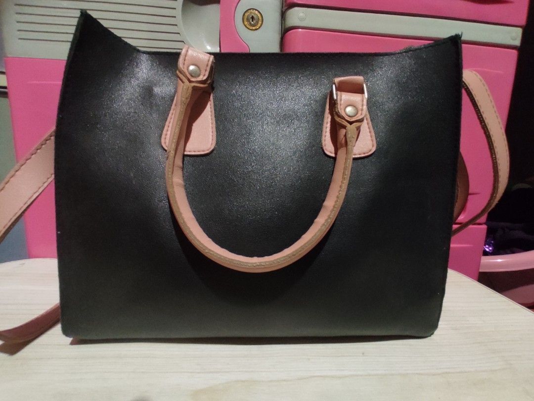 EGG Handcrafted Philippines Black & Pink Tote Bag (Category: Tote Bags) located in Manila. Submitted by xiaochao.16 (Listing ID 1463738999, Image 3). Description: - Stylish black tote bag - Contrasting light pink handles and strap - Interior includes a zippered pocket and main compartment - Proudly made in the Philippines - Minor signs of wear on interior lining - Ideal size for everyday carry.