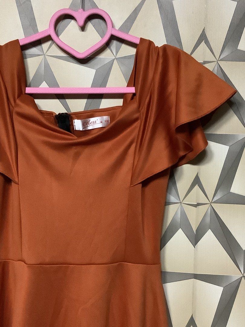 elegant burnt orange / rust evening gown (Category: Evening dresses & gowns) located in Quezon City. Submitted by lovedbyerara (Listing ID 1463692175, Image 2). Description: Silhouette: Classic A-line style with a fitted high-waist band that flows into a floor-length flared skirt. Neckline & Bodice: A square/scoop neckline paired with structured vertical bodice seams to create a tailored, form-fitting look. Sleeves: Playful and feminine flutter s
