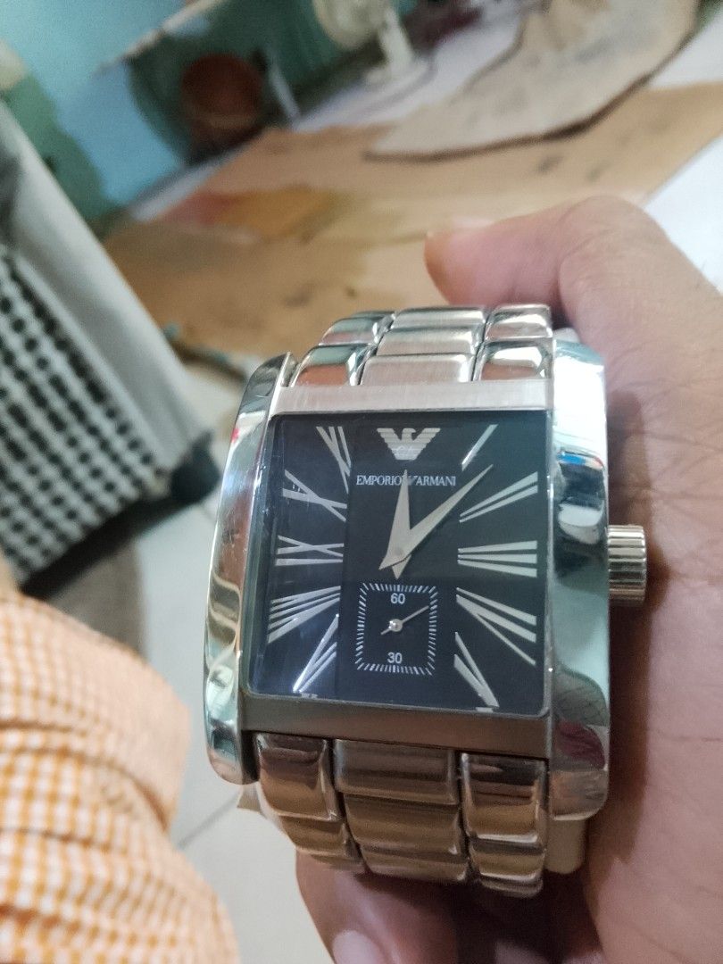 Emporio Armani Watch AR-0181 (Category: Men's Watches) located in Cagayan de Oro. Submitted by brex7 (Listing ID 1463597877, Image 1). Description: - Authentic Emporio Armani Watch (Model AR-0181) - Elegant rectangular face with classic Roman numerals - Convenient small seconds subdial at 6 o'clock - Durable stainless steel case and band - Water resistant up to 50 meters - Versatile for both casual and formal wear.