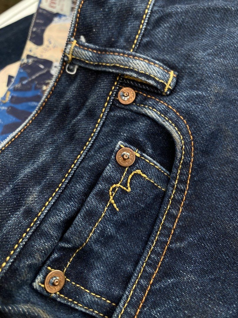 EVISU Jeans 100/72A Size 27 (Category: Luxury Apparel) located in Cagayan de Oro. Submitted by martinduarte22 (Listing ID 1463607361, Image 3). Description: - Authentic Evisu Jeans - Dark Wash Denim - Iconic Seagull Logo on Back Pocket - Button Fly Closure - Red Tab Selvedge Denim - Made in Japan Dimensions: 32 Waistline 38 Length 12 Thigh 7 Hem - Size: 27 on tag (but fit 32 waistline) -Issue: Hairline cracks .