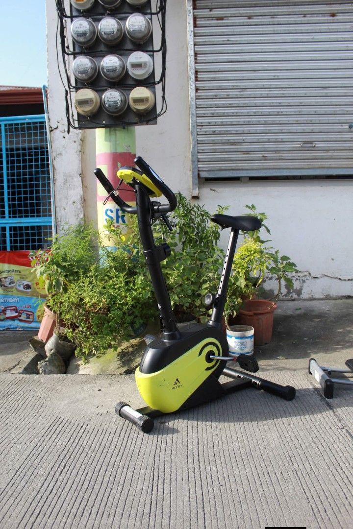 Exercise Bike (Category: Other Home Furniture) located in Meycauayan. Submitted by marygracecasimiro (Listing ID 1463737987, Image 2). Description: ALINCO Exercise Bike and Leg Magic Glider Set Set includes an ALINCO upright magnetic exercise bike with 8-level resistance control, digital display, pulse-rate sensors and a sleek black-and-lime finish, plus a Leg Magic lateral glider with adjustable support handlebars for inner-thigh, outer-thigh an