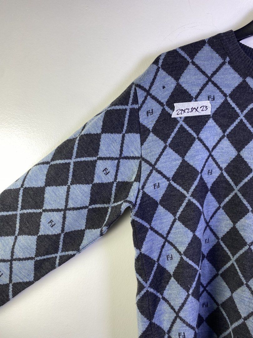 Fendi Argyle Knit Sweater (Category: Longsleeves) located in Manila. Submitted by declutterpromax (Listing ID 1463606146, Image 2). Description: - Classic Fendi sweater - Argyle pattern with Fendi logo throughout - Colorway: Dark grey and light blue - Condition: Some small holes visible on the front - Ideal for Fendi collectors.