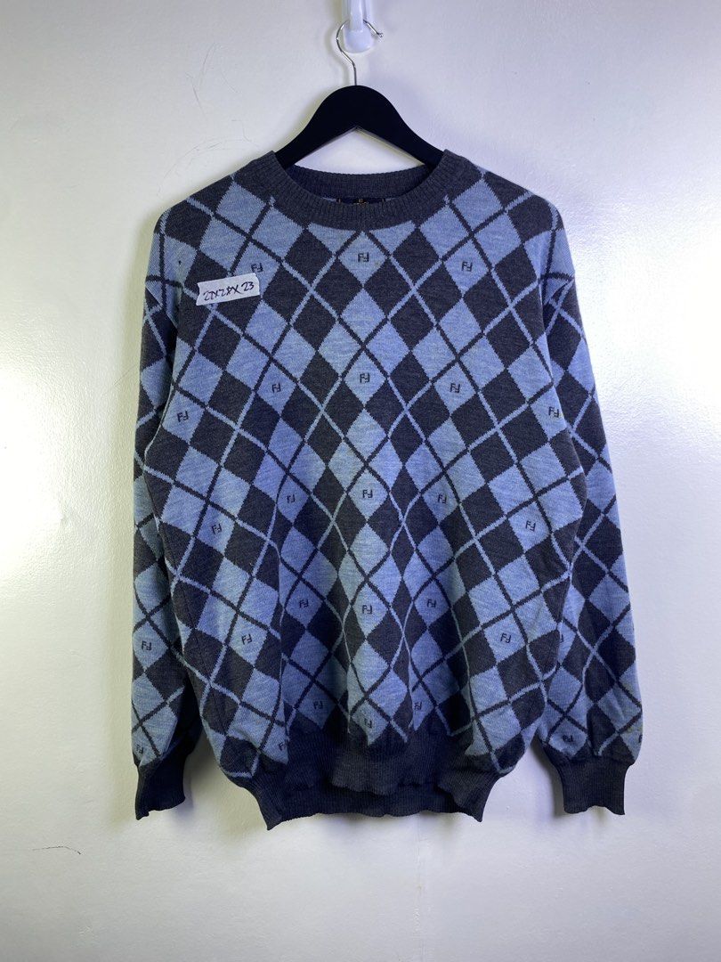 Fendi Argyle Knit Sweater (Category: Longsleeves) located in Manila. Submitted by declutterpromax (Listing ID 1463606146, Image 1). Description: - Classic Fendi sweater - Argyle pattern with Fendi logo throughout - Colorway: Dark grey and light blue - Condition: Some small holes visible on the front - Ideal for Fendi collectors.