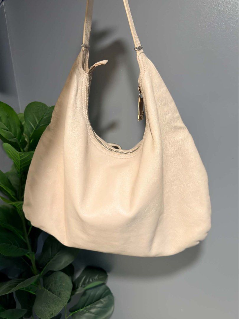 Fendi Leather Zip Hobo Bag (Category: Shoulder Bags) located in Quezon City. Submitted by houseoftrends_ (Listing ID 1463584112, Image 2). Description: - Cream Fendi leather hobo bag - Classic Fendi Zucca print lining - Zippered pockets on the front - Adjustable strap - Nice slouchy shape - Great for everyday use Sellers fave!! 🫶🏼🪬.