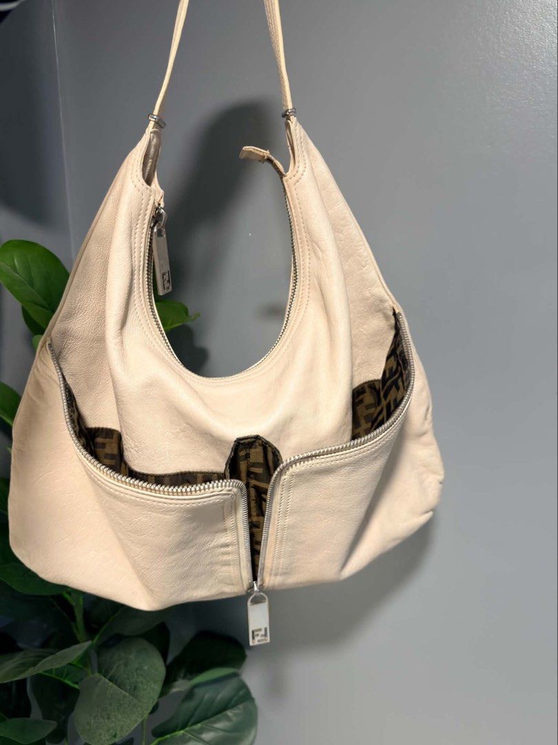 Fendi Leather Zip Hobo Bag (Category: Shoulder Bags) located in Quezon City. Submitted by houseoftrends_ (Listing ID 1463584112, Image 1). Description: - Cream Fendi leather hobo bag - Classic Fendi Zucca print lining - Zippered pockets on the front - Adjustable strap - Nice slouchy shape - Great for everyday use Sellers fave!! 🫶🏼🪬.
