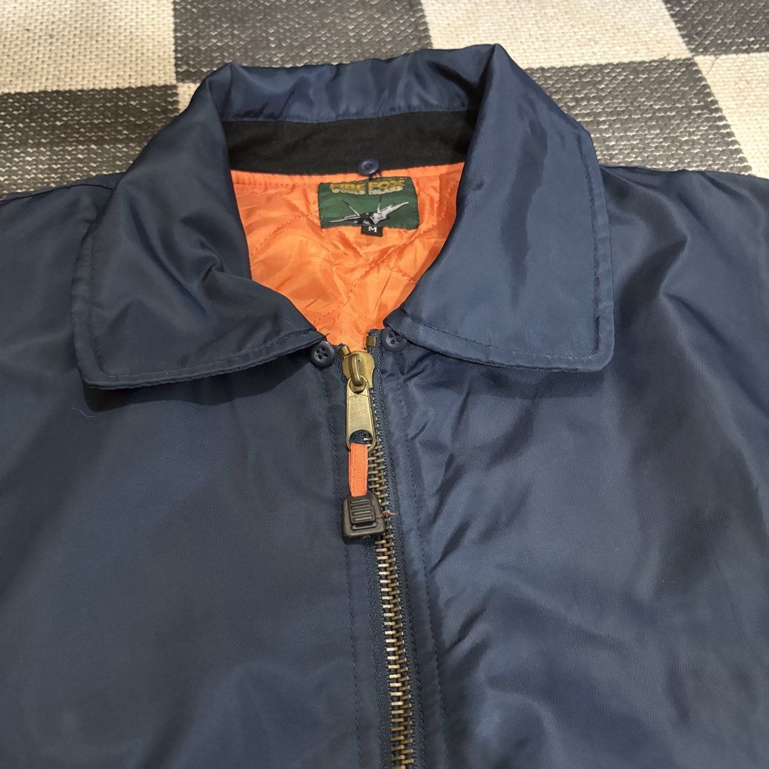 Fire Fox World Island Bomber Jacket Orange Lining Size M (Category: Coats, Jackets and Outerwear) located in Makati City. Submitted by sseurekiii (Listing ID 1463722087, Image 3). Description: - Cool bomber jacket from Fire Fox World Island. - Navy blue exterior with bright orange quilted lining. - Features a collar and zip-up front. - Multiple pockets on sleeves and front for convenience. - Ribbed cuffs and hem for a comfortable fit. - Size: Med