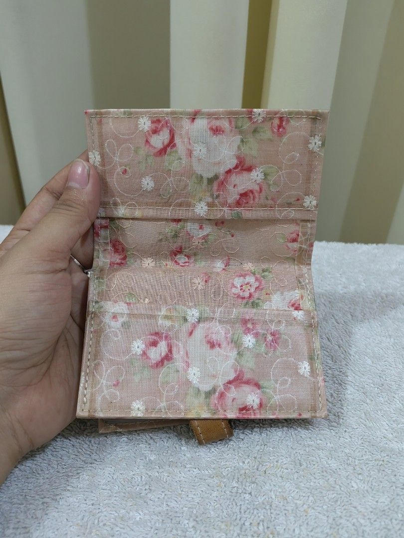 Floral Fabric Card Holder with Leather Strap (Category: Wallets & Card holders) located in Makati City. Submitted by prelovedtreatedwithlove (Listing ID 1463739250, Image 2). Description: - Adorable pink floral design - Secure brown leather strap with snap button closure - Multiple interior slots for cards - Made from soft fabric with a delicate floral print - Perfect for on-the-go organization - Compact and easy to fit in any bag - Made in Japan
