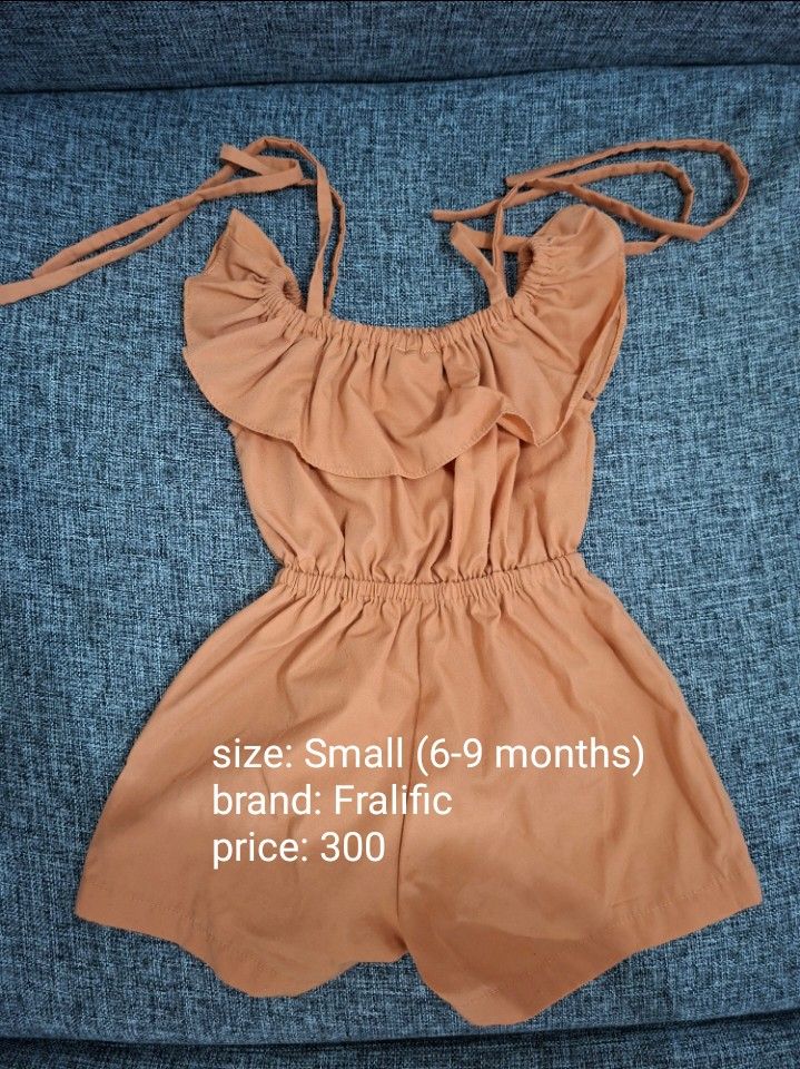 Fralific Baby Romper Size Small (6-9 Months) (Category: Babies & Kids Fashion) located in Makati City. Submitted by calmforest_aea0f7 (Listing ID 1463651805, Image 1). Description: - Adorable orange romper for babies 6-9 months old. - Features charming ruffles and adjustable tie straps. - Comfortable elastic waist for easy wear. - Ideal for sunny summer days. - Brand: Fralific - Selling Price: 300 PHP.