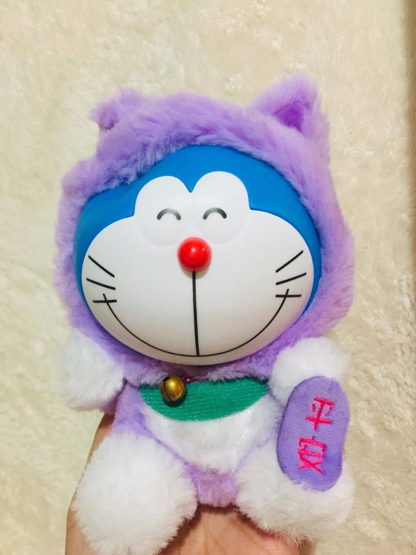 FUJIKO PRO Doraemon lucky cat (Category: Plushies & Soft Toys) located in Baguio. Submitted by izza_thrifty (Listing ID 1463671346, Image 1). Description: - Adorable Doraemon plush toy - Features a cute purple hoodie - Has a little bell around its neck - Super soft and cuddly material - Ideal gift for Doraemon enthusiasts - Approximately [Insert size here if known].