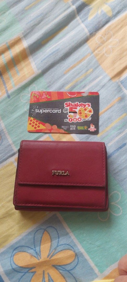Furla Burgundy Leather Tri-fold Wallet (Category: Luxury Bags & Wallets) located in Baguio. Submitted by lotus_blossom (Listing ID 1463556252, Image 1). Description: - Authentic Furla tri-fold wallet - Rich burgundy leather - Secure snap closure - Multiple interior card slots - Convenient coin pocket - Compact and stylish design - Minimal cards lang po, siguro 2 or 3 lang ang Kaya - FLAW, shown on last picture, no other flaws - buyer shoulders sh