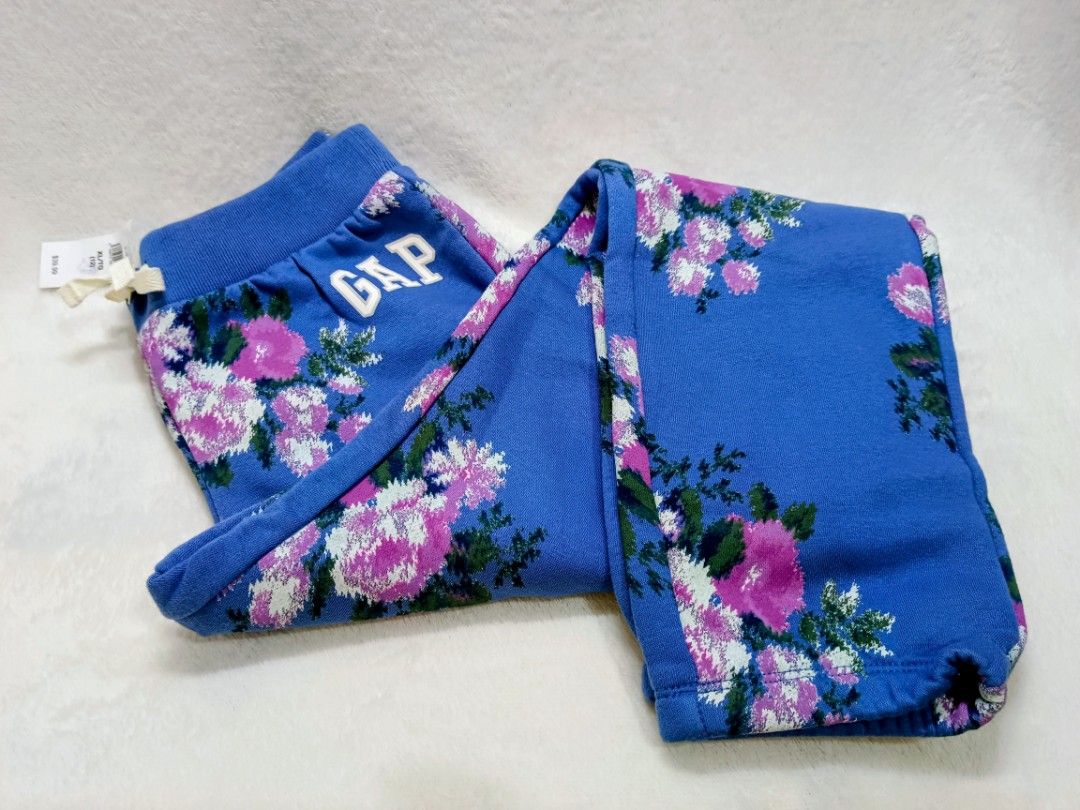 GAP Blue Floral Sweatpants Joggers (Category: Joggers) located in Quezon City. Submitted by shinereign (Listing ID 1463633834, Image 1). Description: - Cute blue sweatpants from GAP - All-over floral print with pink and white flowers - Elastic waistband with drawstring - Ribbed cuffs - Ideal for lounging or casual wear - Comfortable and stylish available size XL (12)''L(10) .