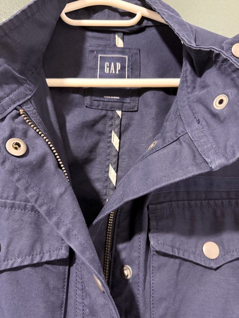 GAP Navy Blue Utility Jacket (Category: Coats, Jackets and Outerwear) located in Pasig City. Submitted by moms_closet2024 (Listing ID 1463663970, Image 2). Description: - Navy blue GAP utility jacket - Size SP (Small Petite) - Zip and button front closure - Multiple functional front pockets - Adjustable drawstring waist - Made in India - Ideal for everyday casual wear.