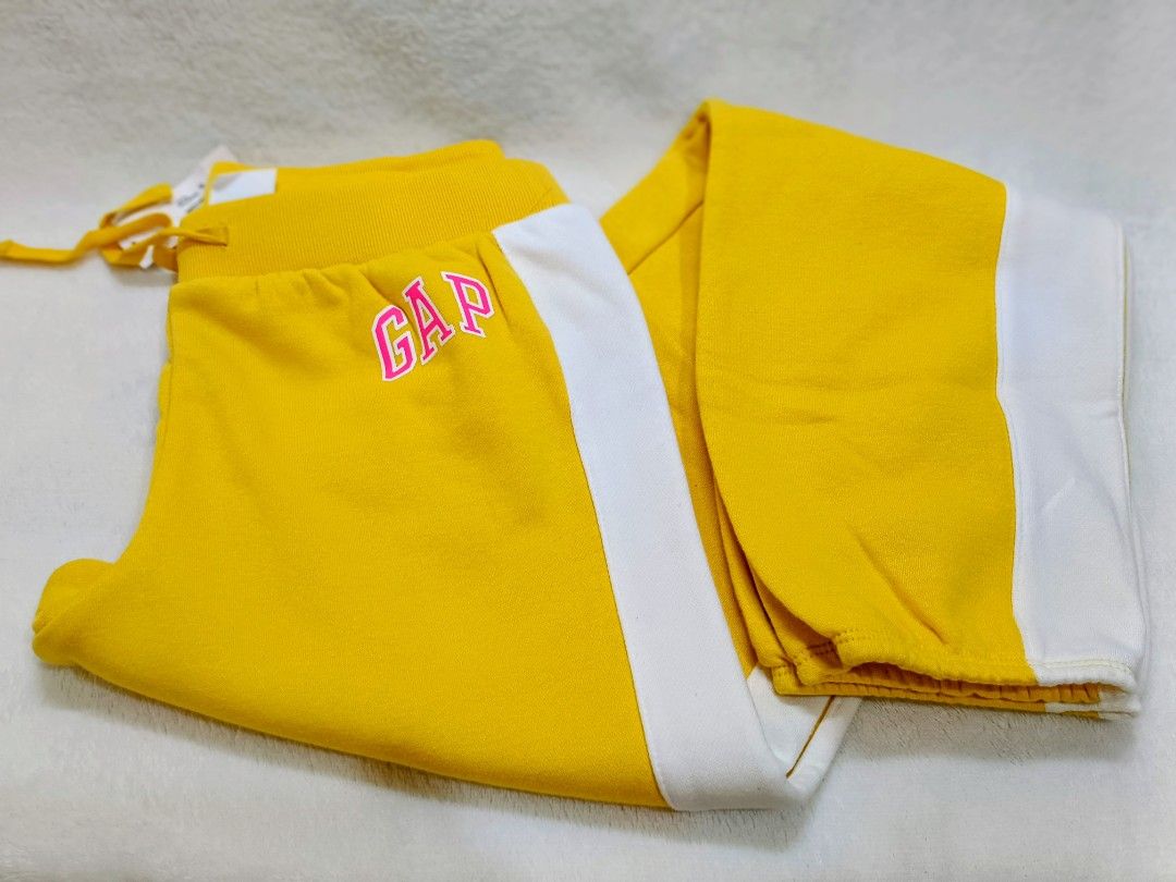 GAP Yellow Sweatpants with White Stripes (Category: Activewear) located in Quezon City. Submitted by shinereign (Listing ID 1463634175, Image 1). Description: - Yellow GAP sweatpants - White stripes down the sides - Drawstring waist for adjustable comfort - Pink embroidered GAP logo on the left leg - Super comfy and stylish for everyday wear size XXL (14-16).