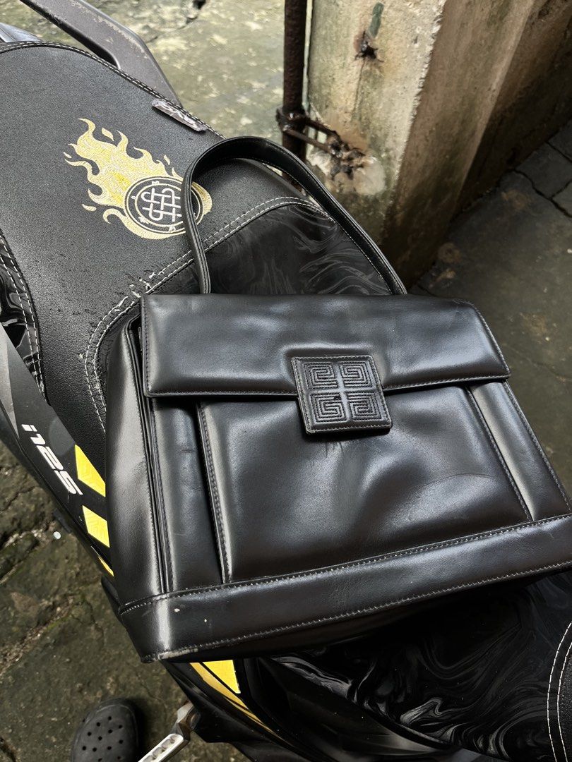 Givenchy Black Leather Handbag (Category: Luxury Bags & Wallets) located in Manila. Submitted by shanaaa.collects (Listing ID 1463574986, Image 1). Description: - Authentic Givenchy black leather handbag - Features iconic Givenchy logo clasp - Interior branding: Givenchy Paris - Closure: Magnetic snap - Condition: Minor scuffing on bottom corners - A classic, timeless piece.