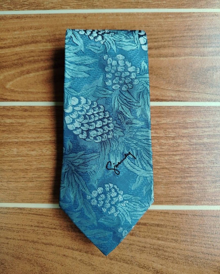Givenchy Tie (Category: Ties) located in Butuan. Submitted by lovzthriftshop. (Listing ID 1463587308, Image 1). Description: ‼️ Givenchy Cravates Silk Tie‼️ ✅ Material : 100% silk ✅ Design : Tropical pineapple and botanical jacquard weave with embroidered Givenchy cursive signature on the front Pre owned condition with tags and no visible flaws 📩 📩 📩.