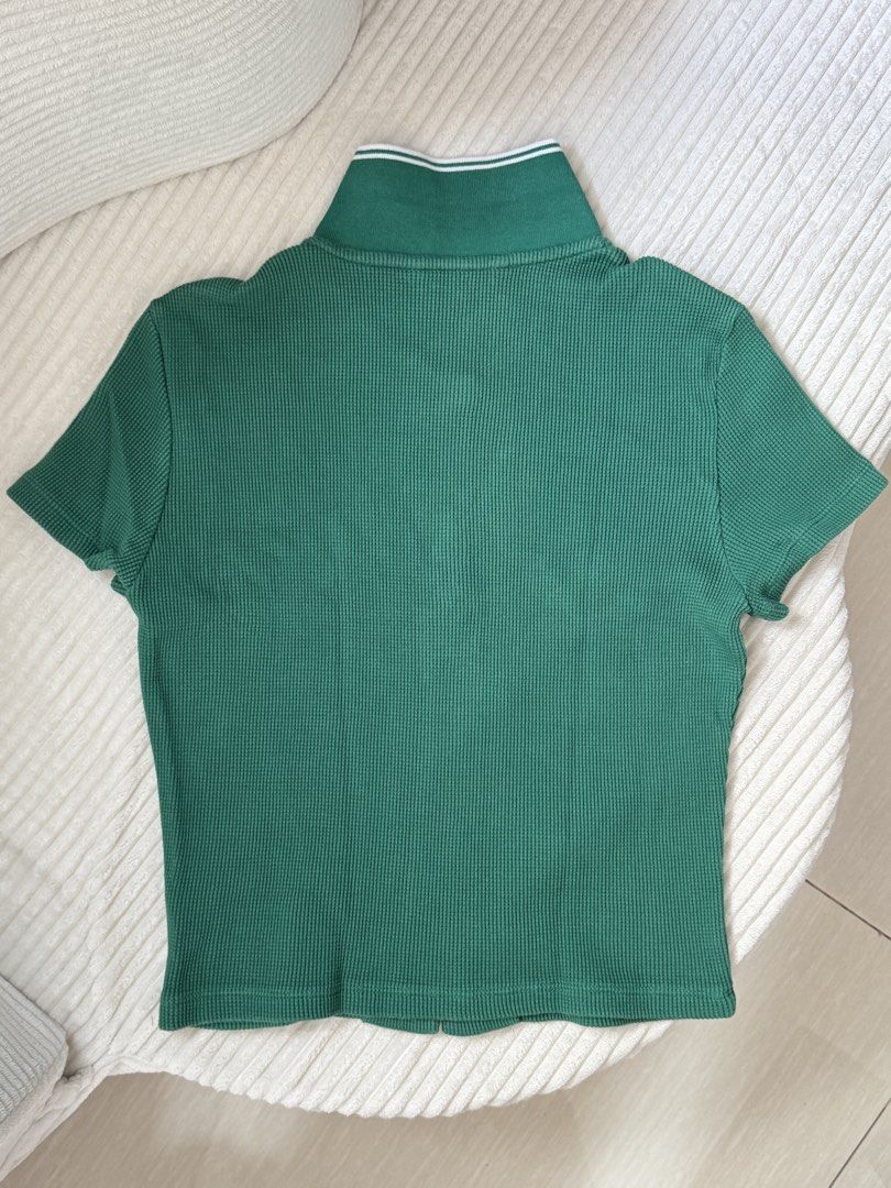 Green Cropped Collared Top with Bear Embroidery (Category: Shirts) located in Dasmarinas. Submitted by ella.i2 (Listing ID 1463635633, Image 2). Description: - Never used (Thrifted) - Collared neckline with button-up front - Short sleeves - Cute bear embroidery with 'BLOOM YOUR WAY TWBEAR' text - Unique waffle texture fabric - Ideal for a fun, casual outfit 📍Dasma.
