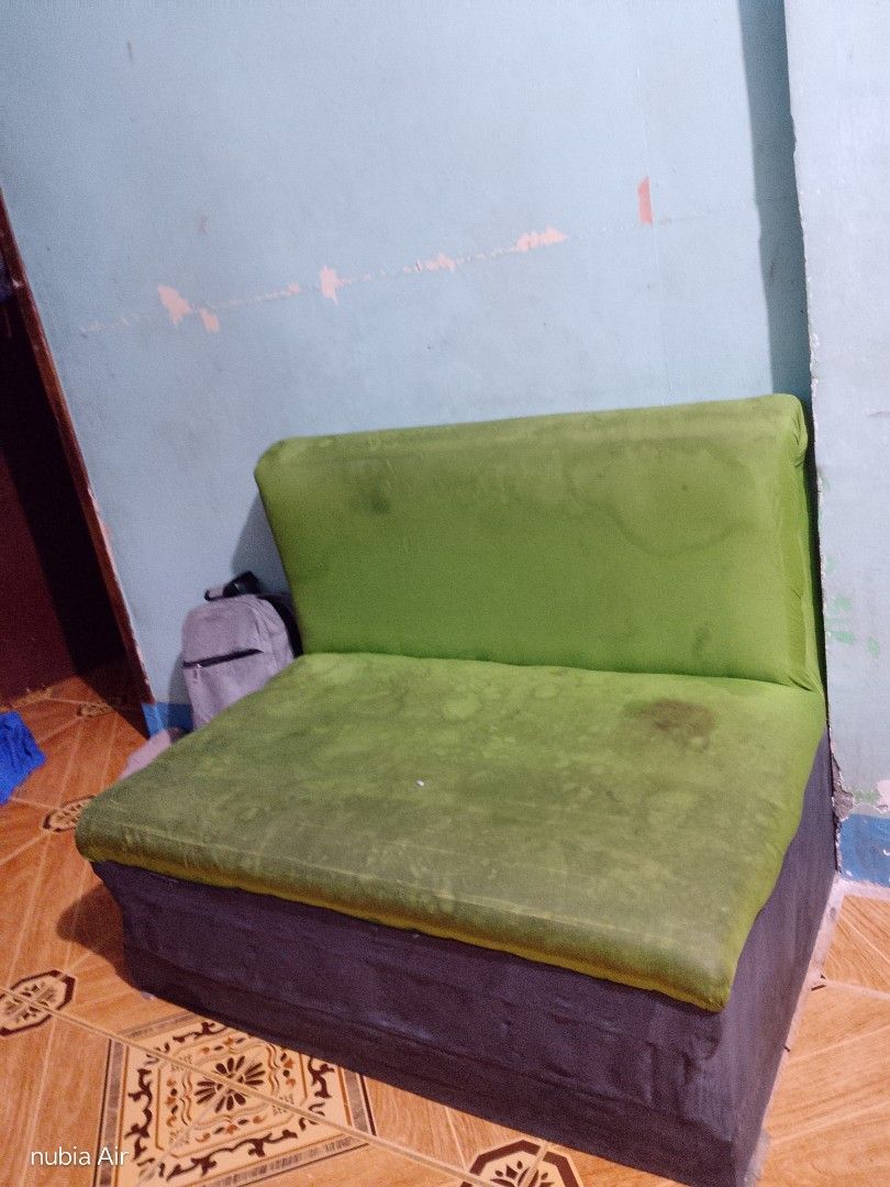 Green Sofa Couch (Category: Sofas) located in Rizal. Submitted by glenamaypi60191 (Listing ID 1463737497, Image 1). Description: - Green 2-seater sofa - Dark grey base - Some stains on green fabric (needs cleaning) - Ideal for small living spaces or extra seating -still firm the foam - Selling as is.