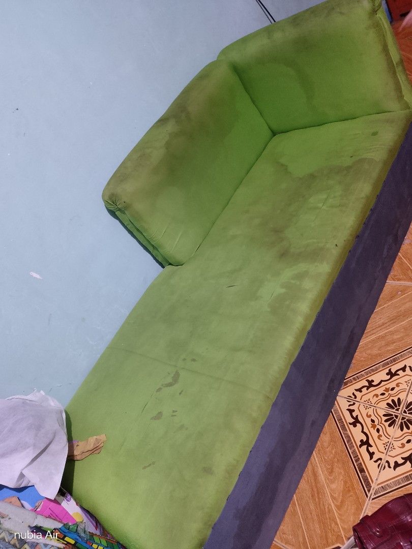 Green Sofa Couch (Category: Sofas) located in Rizal. Submitted by glenamaypi60191 (Listing ID 1463737497, Image 2). Description: - Green 2-seater sofa - Dark grey base - Some stains on green fabric (needs cleaning) - Ideal for small living spaces or extra seating -still firm the foam - Selling as is.