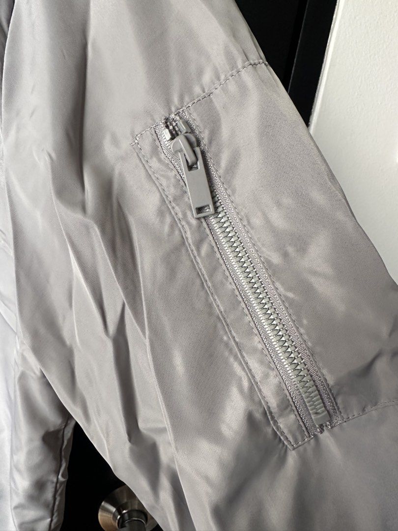 Grey Relaxed Fit Bomber Jacket (Category: Coats, Jackets and Outerwear) located in Paranaque City. Submitted by _tonkatsuclub (Listing ID 1463627234, Image 2). Description: - Color: Grey - Style: Bomber Jacket - Fit: Relaxed - Size: L - Zippered sleeve pocket, ribbed collar, cuffs, and hem.