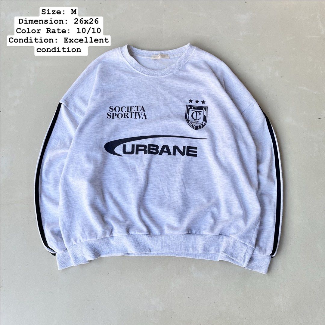 Grey "Urbane" Graphic Sweatshirt Size M (Category: Coats, Jackets and Outerwear) located in Mandaue City. Submitted by chinsyap_03 (Listing ID 1463630424, Image 1). Description: - Grey sweatshirt with 'Societa Sportiva' and 'Urbane' graphics - Features black stripes on the sleeves - Crew neck, long sleeves - Ribbed cuffs and hem - Made from soft, comfortable fabric - Ideal for casual wear.