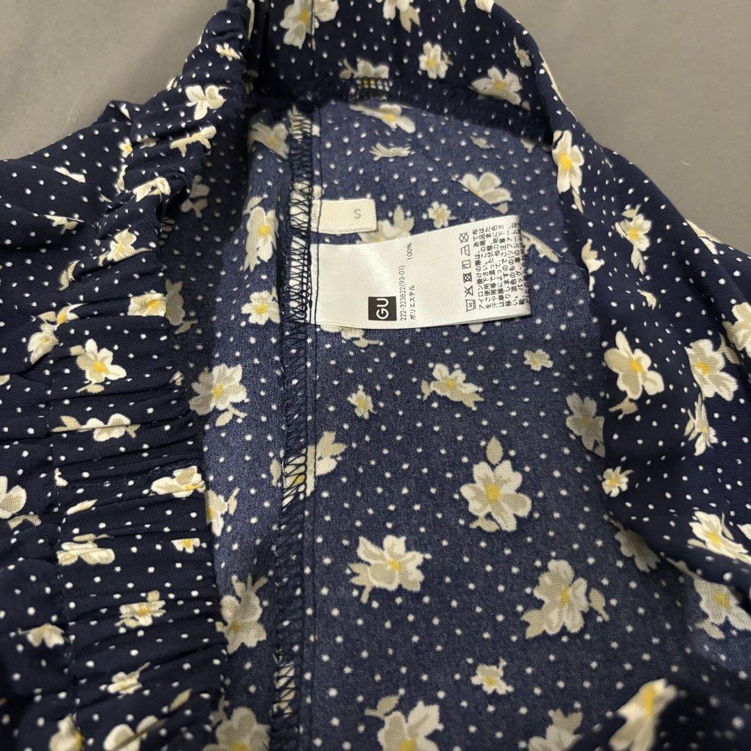 GU Navy Floral Midi Skirt (Category: Skirts) located in Makati City. Submitted by sseurekiii (Listing ID 1463721390, Image 2). Description: - Navy blue midi skirt - White and yellow floral print - Scattered white polka dots - Comfortable elastic waistband - Flowy A-line silhouette - Versatile for casual or dressed-up looks.