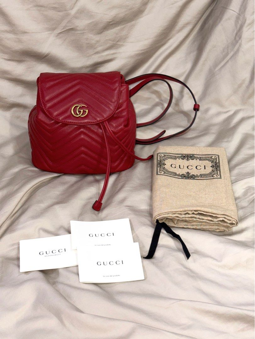GUCCI | GG Marmont Matelasse Mini Flap Backpack (Category: Backpacks) located in Muntinlupa City. Submitted by diananeedsspace (Listing ID 1463602289, Image 1). Description: - Authentic Gucci backpack in vibrant red. - Crafted from quilted leather with iconic GG logo hardware. - Features a secure drawstring closure. - Adjustable straps for comfortable wear. - Comes complete with original dust bag and authenticity cards. - Ideal for both everyday 
