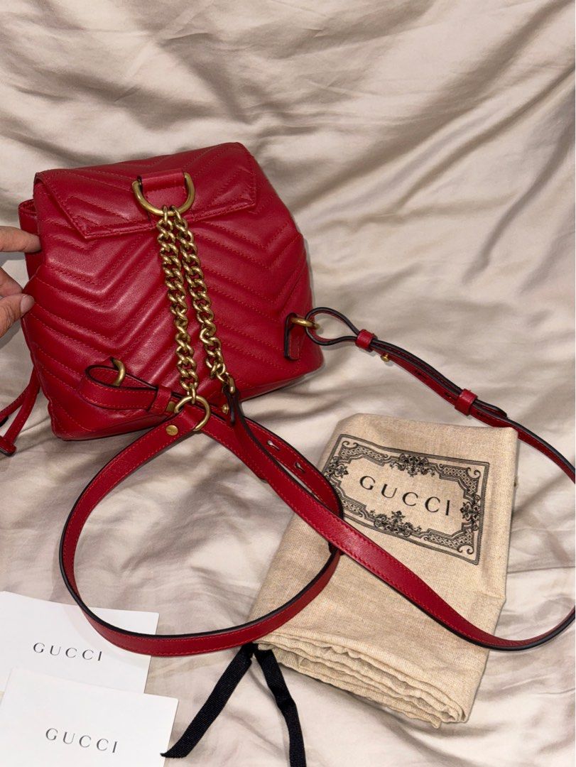 GUCCI | GG Marmont Matelasse Mini Flap Backpack (Category: Backpacks) located in Muntinlupa City. Submitted by diananeedsspace (Listing ID 1463602289, Image 2). Description: - Authentic Gucci backpack in vibrant red. - Crafted from quilted leather with iconic GG logo hardware. - Features a secure drawstring closure. - Adjustable straps for comfortable wear. - Comes complete with original dust bag and authenticity cards. - Ideal for both everyday 