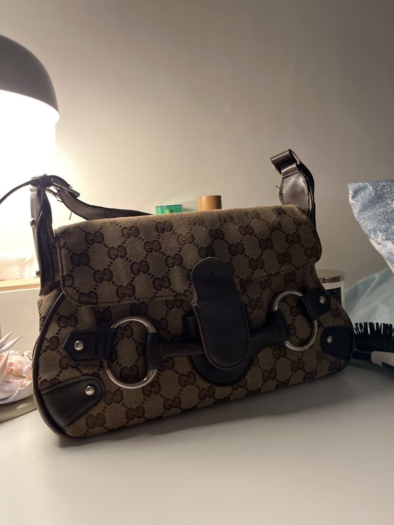 Gucci Monogram Canvas Shoulder Bag (Category: Luxury Bags & Wallets) located in Manila. Submitted by unicahija.boutique (Listing ID 1463679635, Image 2). Description: - Gucci shoulder bag - Classic GG monogram canvas - Dark brown leather trim - Iconic horsebit hardware - Some wear on strap and flap closure - Ideal everyday bag for essentials issues: Rubber lining Gold hardware discoloration.