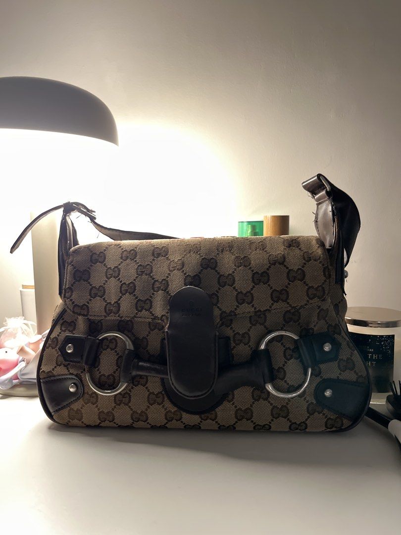 Gucci Monogram Canvas Shoulder Bag (Category: Luxury Bags & Wallets) located in Manila. Submitted by unicahija.boutique (Listing ID 1463679635, Image 1). Description: - Gucci shoulder bag - Classic GG monogram canvas - Dark brown leather trim - Iconic horsebit hardware - Some wear on strap and flap closure - Ideal everyday bag for essentials issues: Rubber lining Gold hardware discoloration.