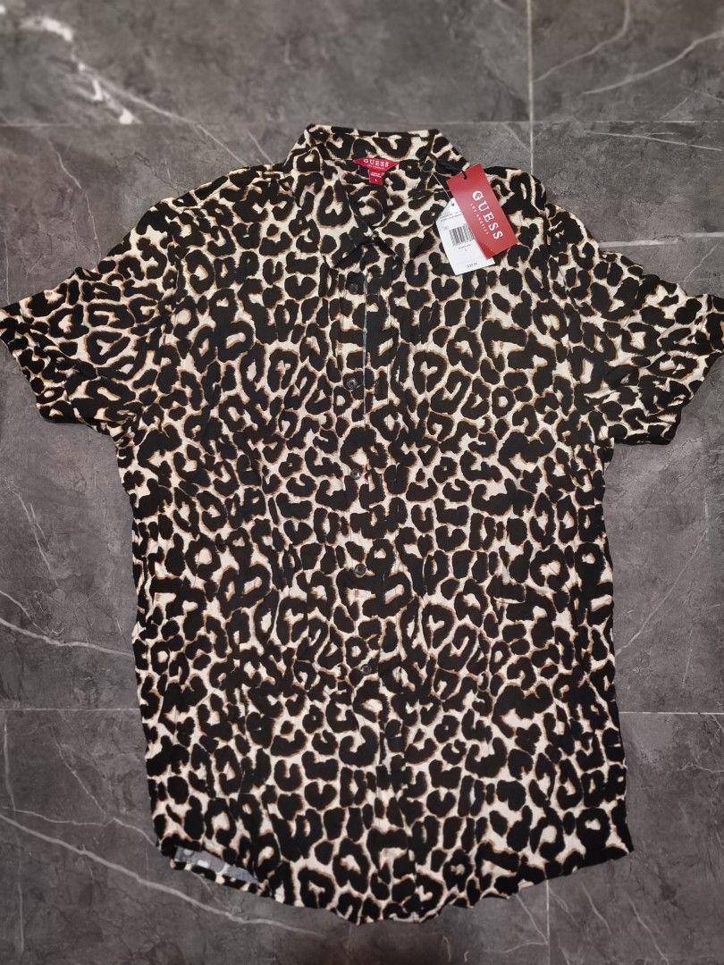 Guess Leopard Print Short Sleeve Button Up Shirt (Category: Tshirts & Polo Shirts ) located in Makati City. Submitted by nida.hernandez (Listing ID 1463728081, Image 1). Description: "Brand new with tags (BNWT) tops. Never worn, just kept in the cabinet. Selling them cleared out!" short sleeve shirt #guess #addidas #nike #tommyhilfiger #champion #freeplanet #drifit all original 💯 authentic - Eye-catching leopard print - Button-up style - Size L 