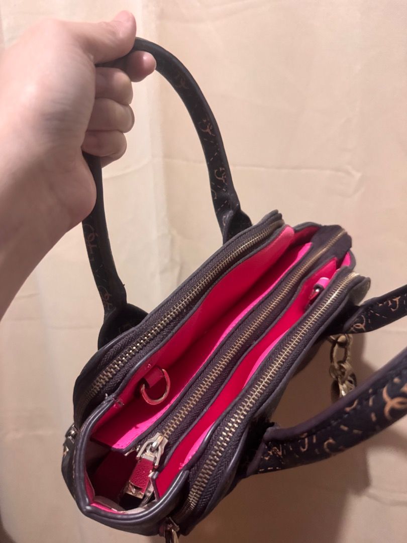 Authentic Guess Monogram Satchel Bag (Category: Shoulder Bags) located in Imus. Submitted by jazzmin04 (Listing ID 1463703766, Image 3). Description: - Stylish Guess monogram satchel bag in brown and tan. - Eye-catching bright pink interior with multiple compartments for organization. - Comes with a detachable shoulder strap for versatile carrying options. - Ideal everyday bag for your essentials. - Clean inside - Overall perfect bag but Pink par