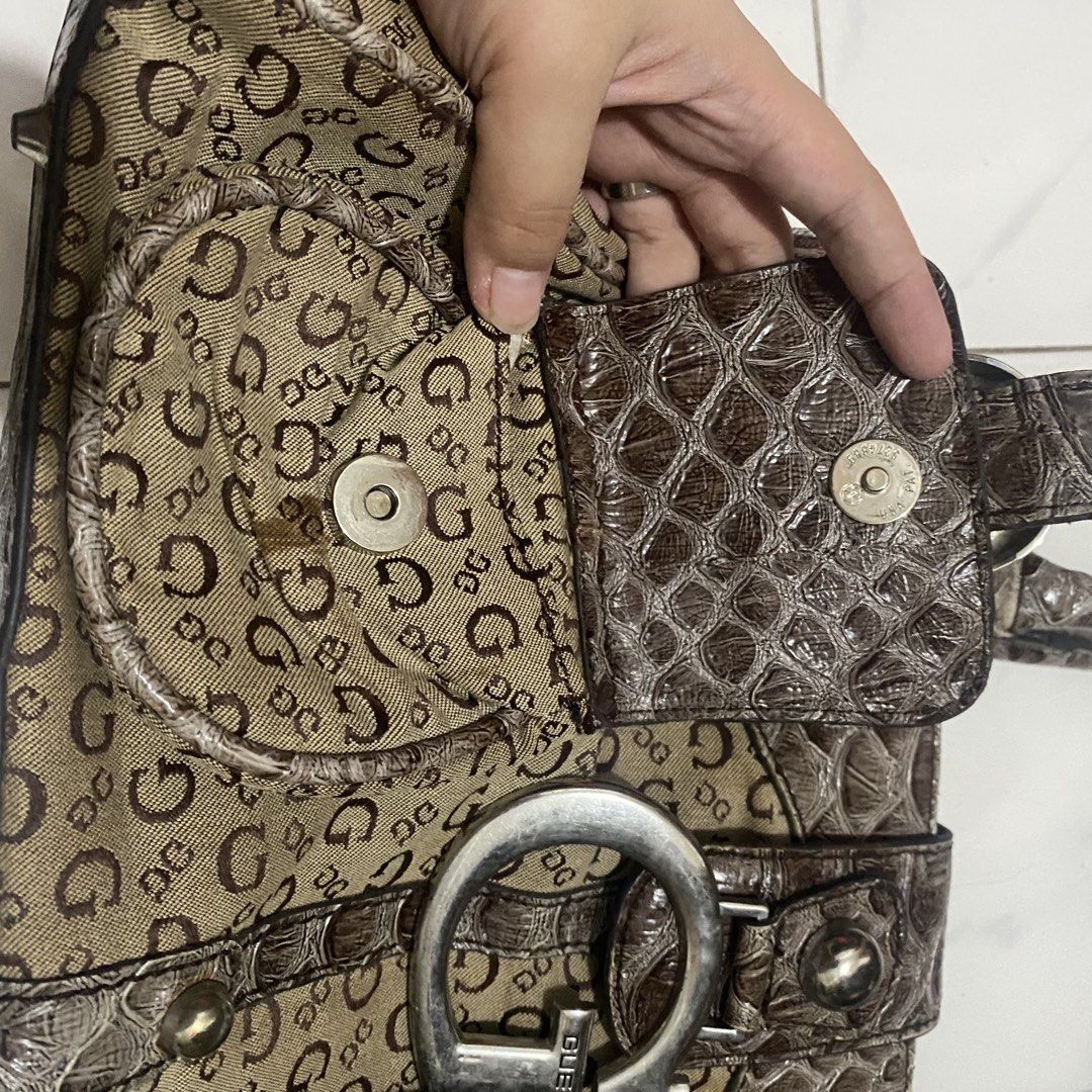 Guess Vintage Monogram Shoulder Bag (Category: Shoulder Bags) located in Manila. Submitted by dejesusjustin0704 (Listing ID 1463598926, Image 3). Description: - Authentic brown Guess shoulder bag - Signature G monogram print all over - Elegant croc-embossed accents - Large silver G logo on the front - Decorative buckle details on front pockets - Comfortable top handle for carrying - Secure zipper closure for main compartment.