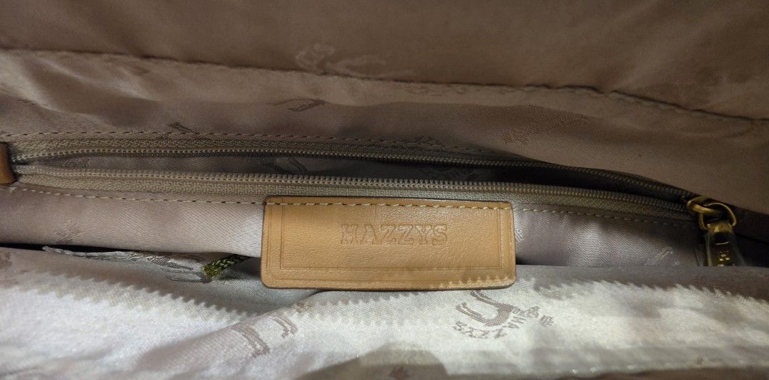 Hazzys Leather Tote Bag Tan Gold Hardware (Category: Tote Bags) located in Manila. Submitted by amc88 (Listing ID 1463612002, Image 3). Description: - Genuine tan leather tote bag by Hazzys - Elegant gold hardware and signature 'H' logo - Interior features branded lining and a secure zippered compartment - Comes with a detachable shoulder strap for versatile carrying - Spacious design, ideal for your daily essentials - Barely noticeable signs of 