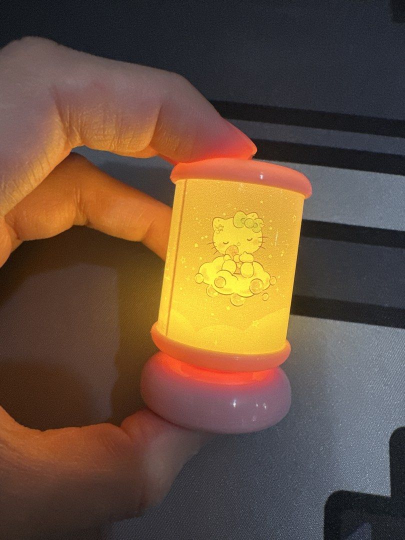 Hello Kitty Mini Night Light Lamp gacha (Category: Lighting) located in Manila. Submitted by lunalux09 (Listing ID 1463657969, Image 3). Description: - Adorable Kitty night light - Features a sleeping Kitty on the moon design - Emits a warm, comforting glow - Perfect for children's bedrooms or as a decorative accent - Compact and portable size - Battery operated for easy placement.