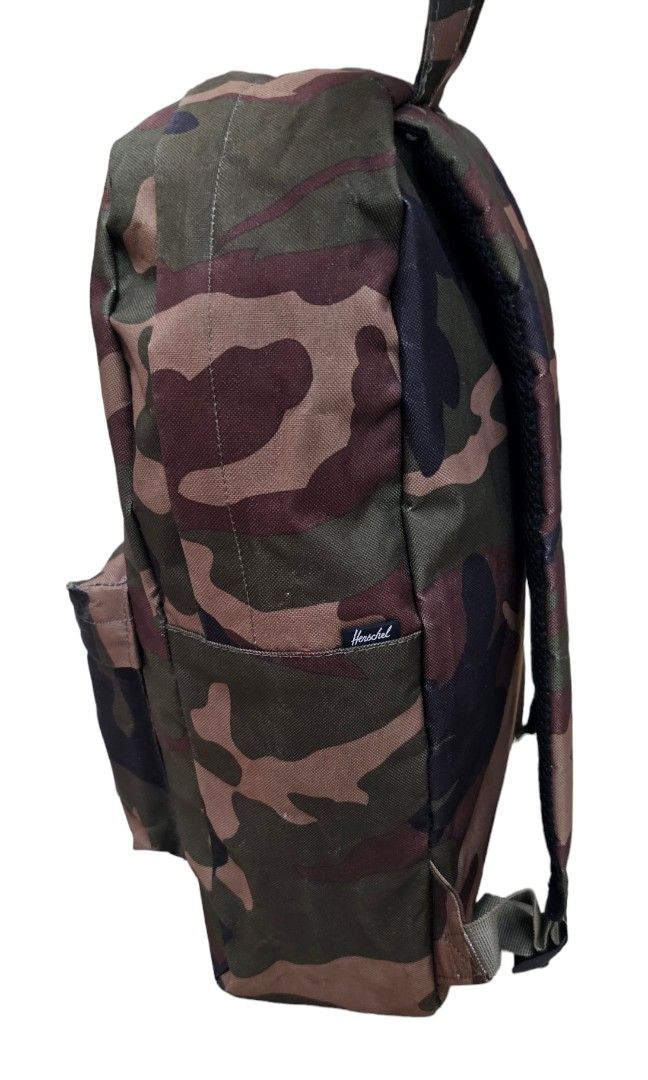 Herschel Camo Backpack 12x17x4.5 inches (Category: Backpacks) located in Pasig City. Submitted by chichirepublic (Listing ID 1463669719, Image 3). Description: - Classic Herschel backpack in a cool camouflage print. - Dimensions: Approx. 12" wide, 17" tall, 4.5" deep. - Features a convenient front pocket with a zipper. - Signature Herschel logo patch on the front. - Padded shoulder straps for maximum comfort. - Ideal for school, work, or everyday