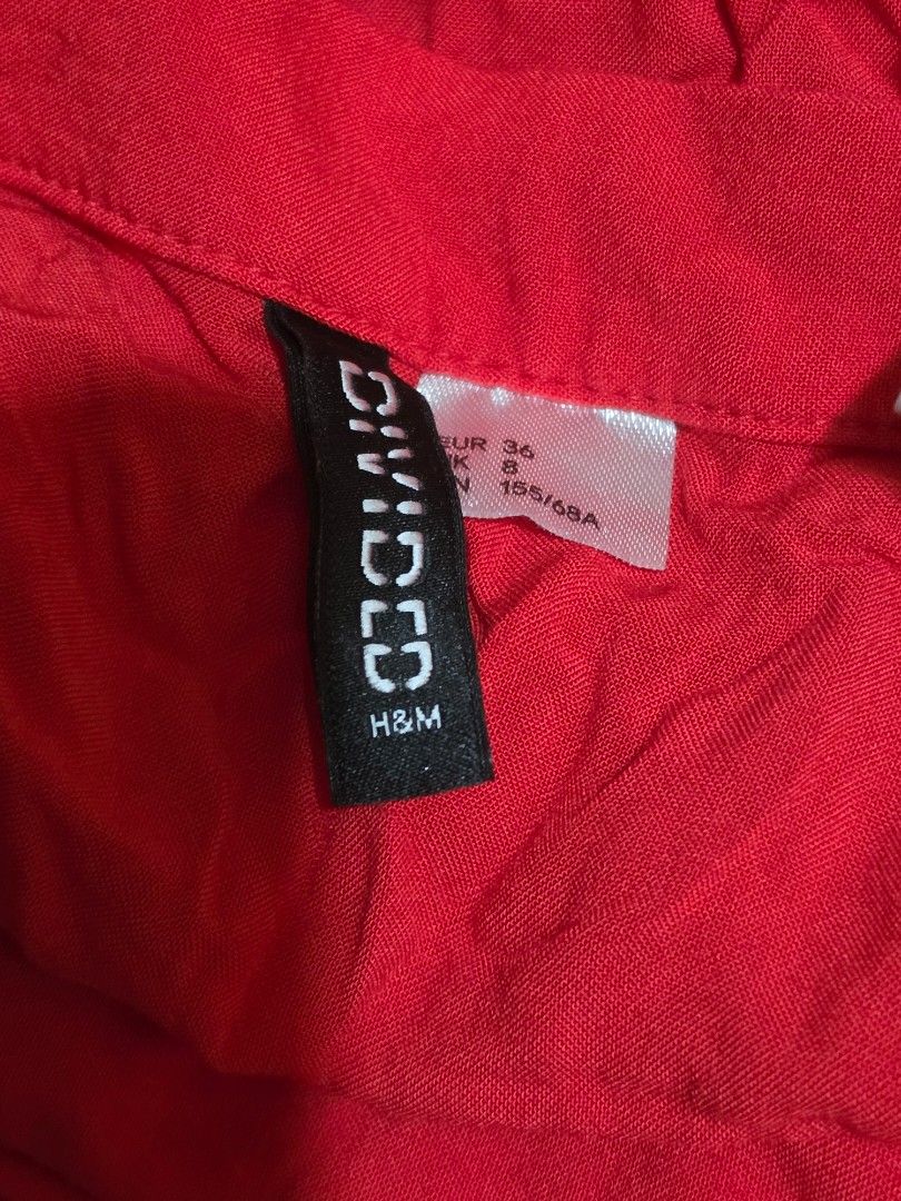 H&M Divided Red Wrap Skirt (Category: Skirts) located in Malabon City. Submitted by lpzangie (Listing ID 1463691053, Image 3). Description: - H&M Divided Red Wrap Skirt - Material: 100% Viscose - Features adjustable tie straps for a custom fit - Versatile: Great for casual wear - Easy to style.