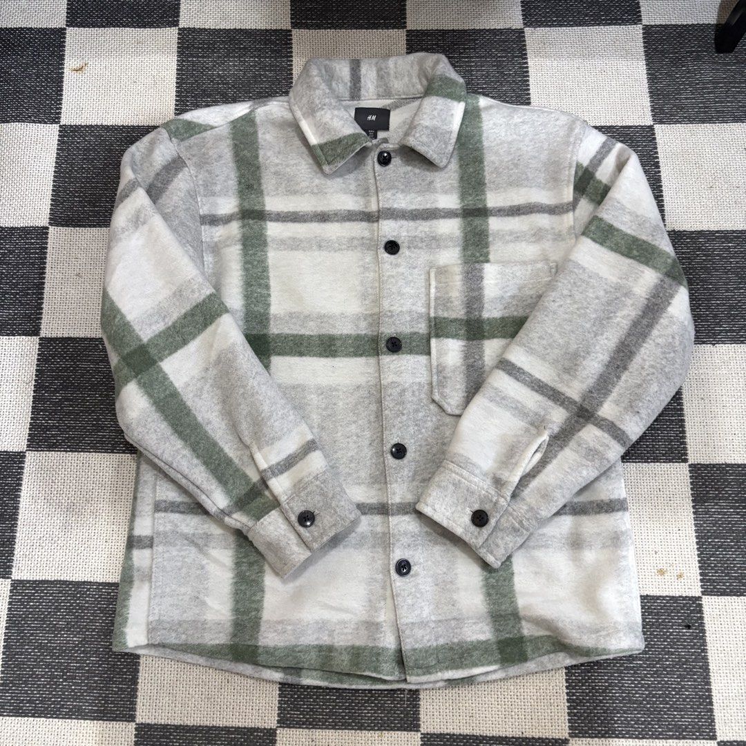 H&M Plaid Shirt Jacket Grey Green (Category: Coats, Jackets and Outerwear) located in Makati City. Submitted by sseurekiii (Listing ID 1463722063, Image 2). Description: - Grey and green plaid shirt jacket - Brand: H&M - Button-up front closure - Single chest pocket - Long sleeves with button cuffs - Cozy material, ideal for layering.